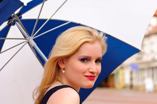 Girl with umbrella in the city