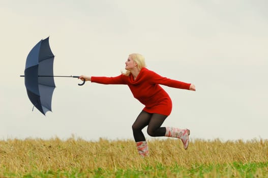 Woman chases umbrella after