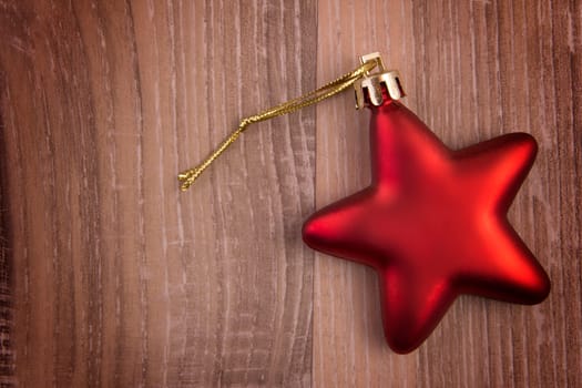 Red Christmas star on wood background