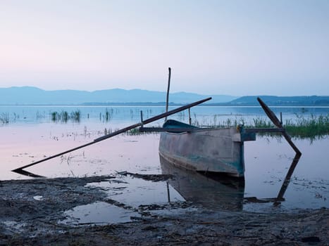 Fishing boat in the lake at dawn