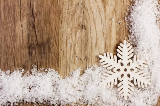 Poinsettia on snow with wooden background