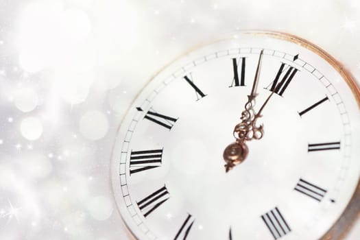 New Year's at midnight - Old clock with stars snowflakes and holiday lights