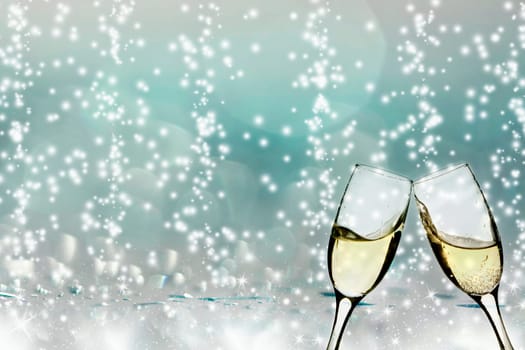 Glasses with champagne against holiday lights