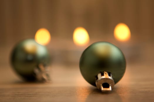 Christmas decoration on wood with candle flames in the background