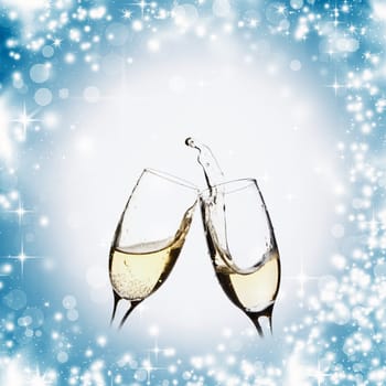 Glasses with champagne against holiday lights