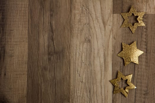 Christmas decoration gold on brown wooden background