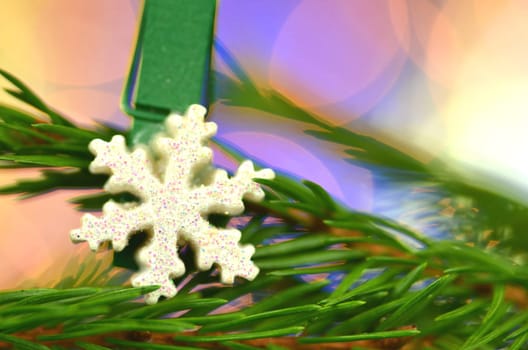 christmas decoration, snow flake on clip against bokeh background