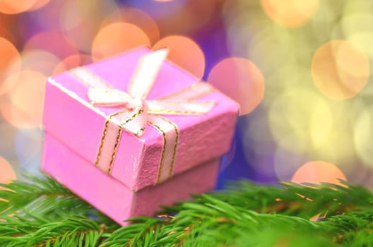 christmas decoration, pink Christmas present against bokeh background