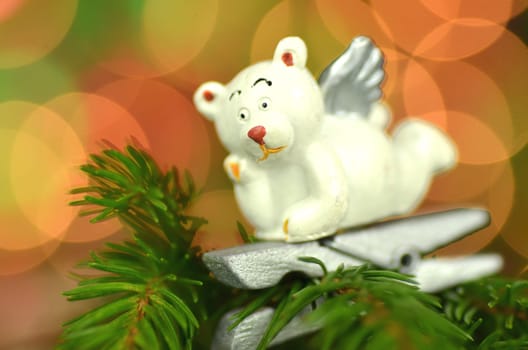 christmas decoration, white bear angel on clip against bokeh background