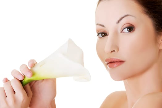 portrait of beautiful adult woman with health skin and with lily flower over white background.