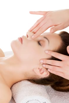 beautiful young woman enjoys massage at saloon spa. isolated on white.