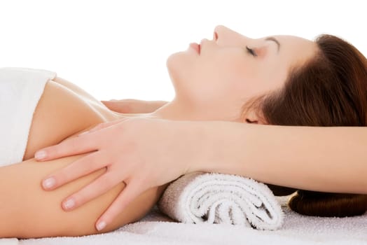 beautiful relaxed young woman enjoy receiving face massage at a spa saloon. isolated on white.