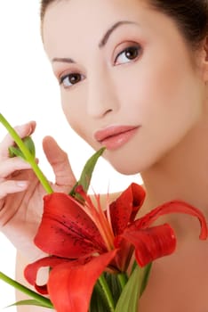 portrait of beautiful adult woman with red lily flower. isolated on white.
