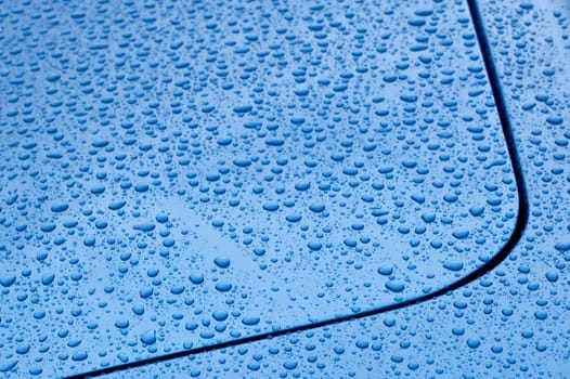raindrop covered blue vehicle panel abstract