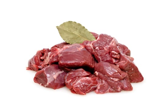Raw game meat from the deer as goulash with bay leaf