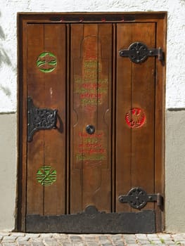 frontal view of a single medieval door artistically painted in the city of Ulm (Baden-Würtemberg) Summer 2012