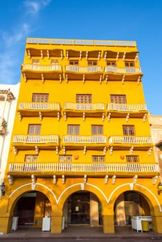 Historic architecture of a yellow colonial building in the historic center of Cartagena, Colombia