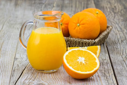 orange juice and fresh fruits on wooden background
