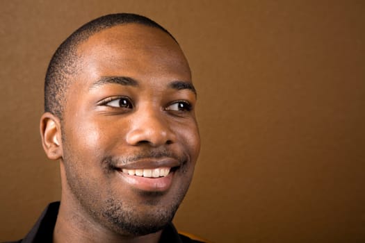 Portrait of a handsome young black man with dark background