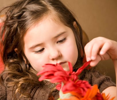Portrait of a beautiful little girl with flowers