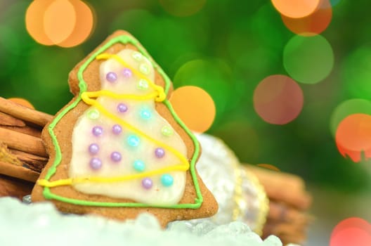 Delicious decorated Christmas cookies on bokeh background