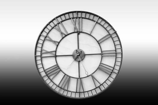 The close-up of an isolated wall clock against a homogeneous background.