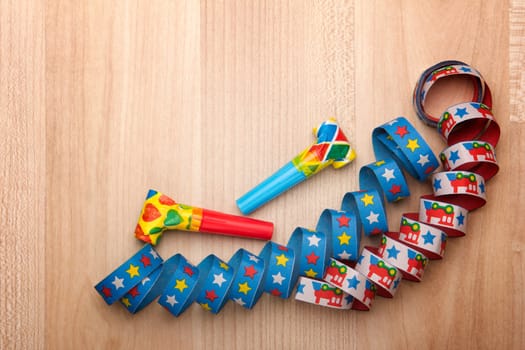 Streamers and confetti on wooden background