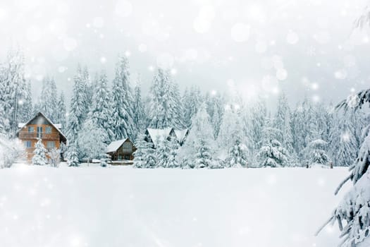 Winter landscape with snowy fir trees and mountain cotage