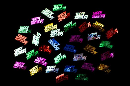Colorful Happy birthday Confetti isolated on black