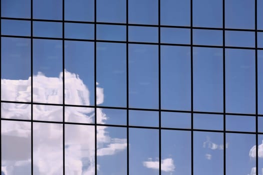 Reflections of clouds and sky on a shiny surface