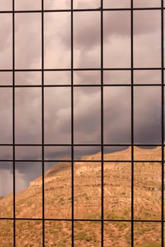 Reflections of clouds and mountain on a shiny surface