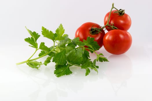 Fresh parsley and tomatoes on white background