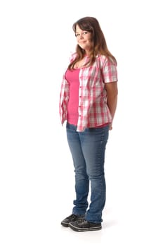 Girl with long dark hair wears a checkered blouse and jeans,stands in front of a white background