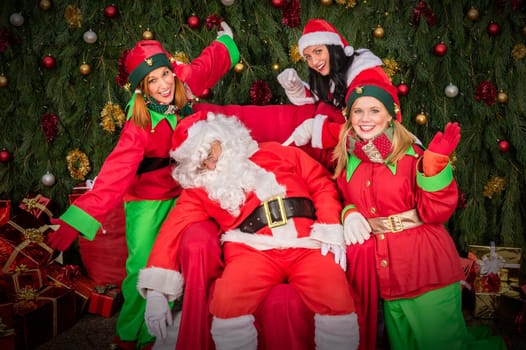 Tired Santa Clause with elf helper sleep chair Christmas decoration