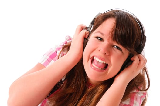Young mGirl with long dark hair listens enthusiastically to music with headphones against a white background.