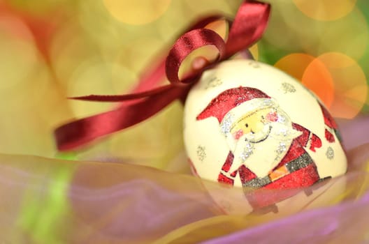 Christmas bauble  made by decoupage technique on bokeh background