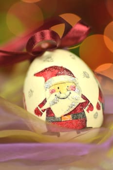 Christmas bauble  made by decoupage technique on bokeh background