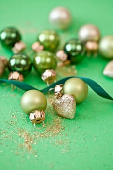 Christmas tree baubles in green tones and glittering hearts for Christmas