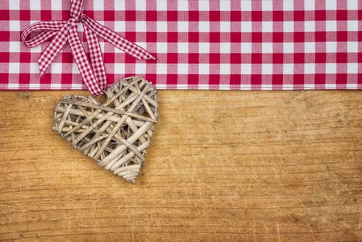 Rustic wooden background with a braided heart
