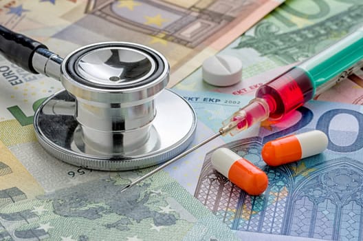 Stethoscope and medicines on banknotes