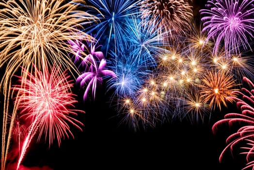 Atmospheric colorful fireworks on black,with text space