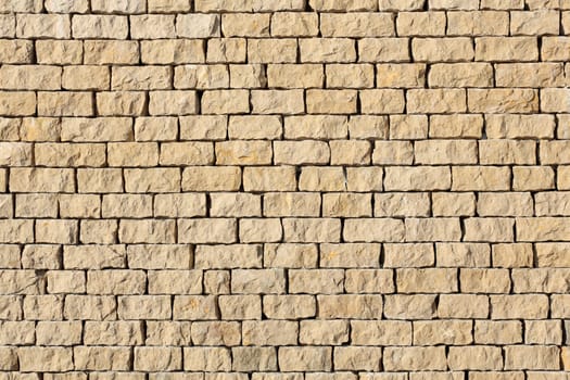 Detail of a outdoors wall made with stone stacked.