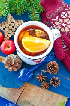 Hot punch with fresh oranges in winter