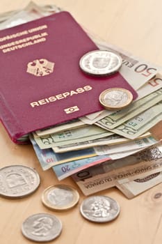 German passport with various currencies