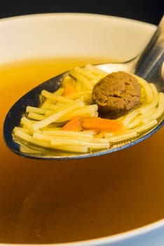 Beef broth with pasta and meatballs