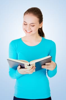 young woman reading an old book
