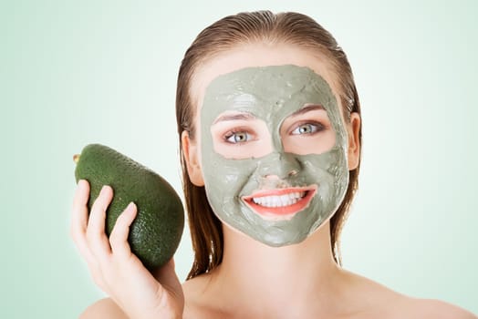 beautiful woman with green avocado clay facial mask
