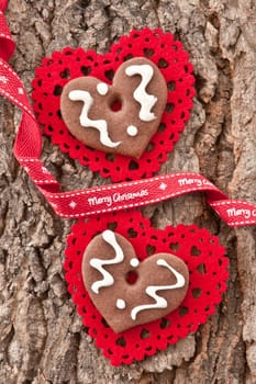 Heart-shaped gingerbread on rustic bark background