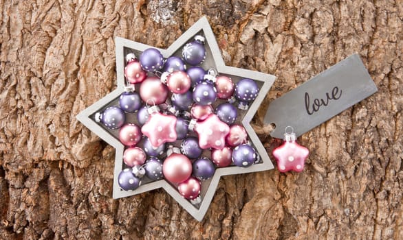 Rustic wooden background with colorful Christmas baubles for Christmas