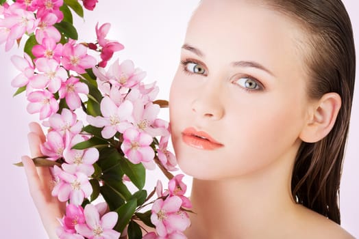 beauty face of the young beautiful woman with flower.